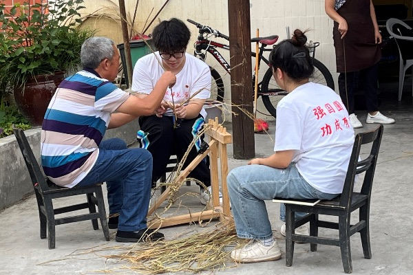 团队成员学习编织草鞋。开云kaiyun官方网站供图
